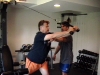 Eric helps client Ed with rope tricep extension.