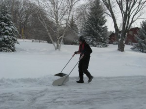 Heather uses a snow scoop