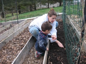 Heather and child planting seeds